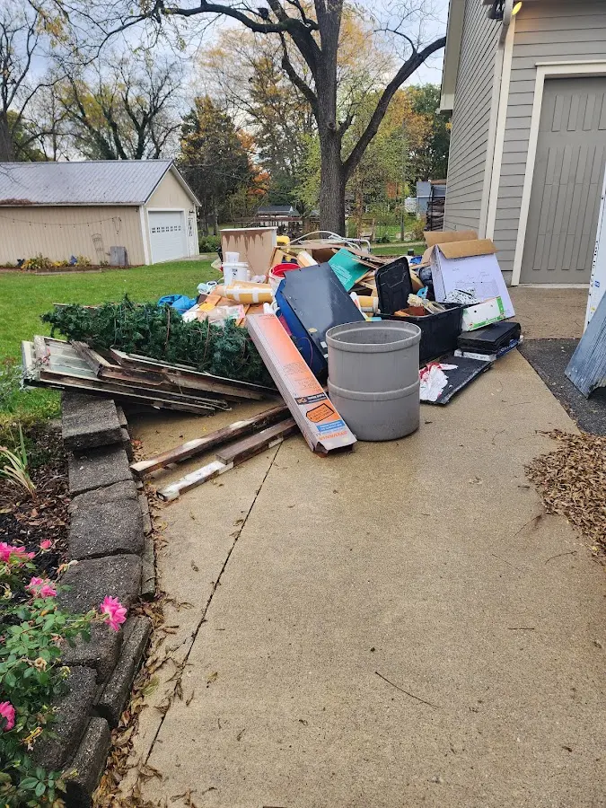 Dumpster being loaded with debris for Estate Cleanout Dumpster Rental in Thibodaux
